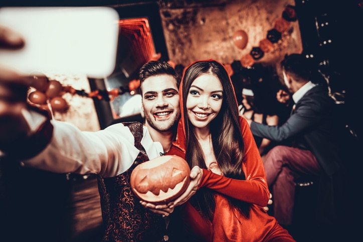 Young Couple in Halloween Costumes taking Selfie